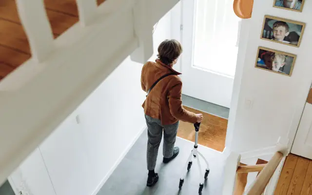 Older adult walking safely at home with a rollator