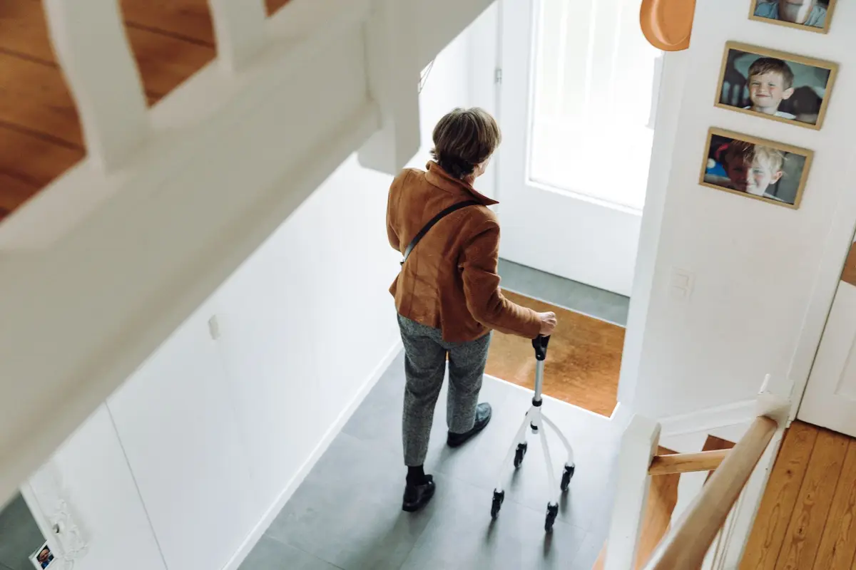 Older adult walking at home with a rollator