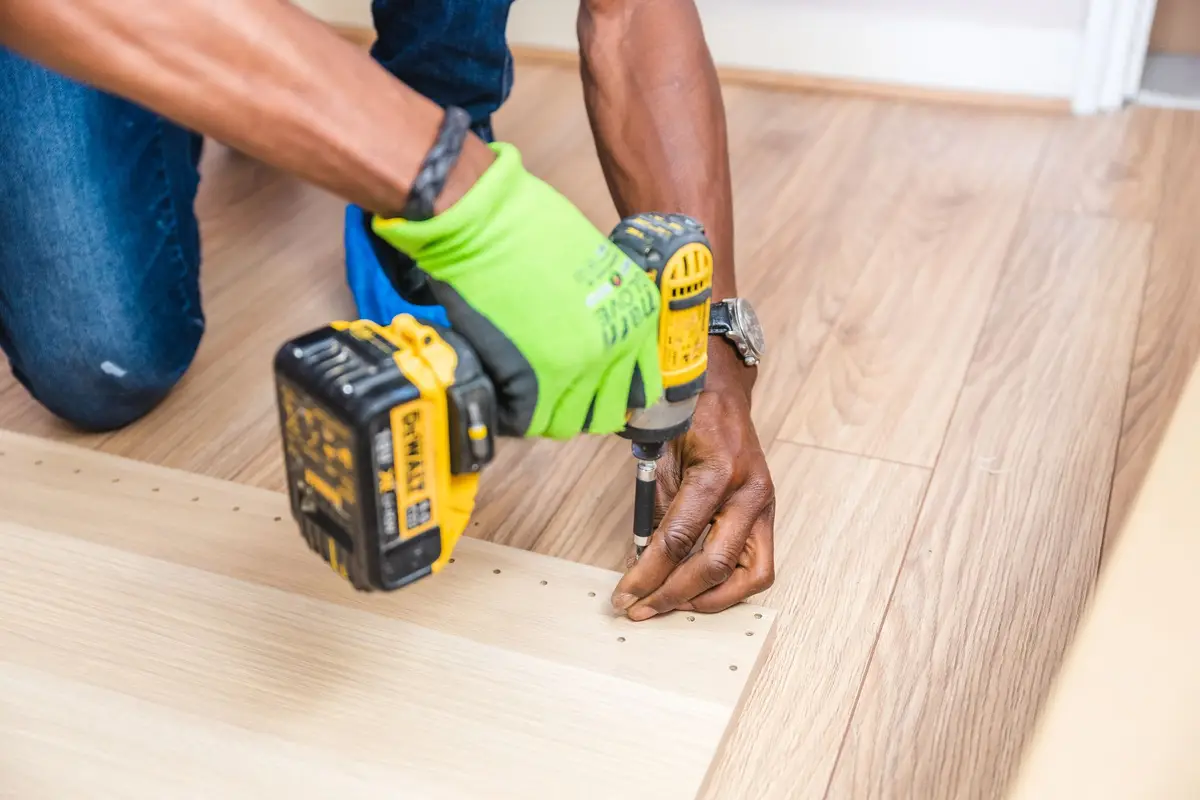 Handyman drilling a board with a cordless drill
