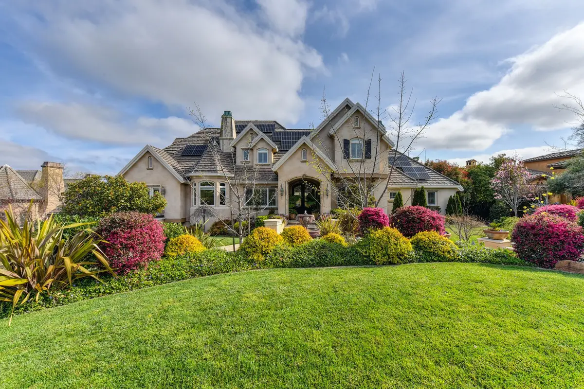 Front yard with flower beds and a green lawn