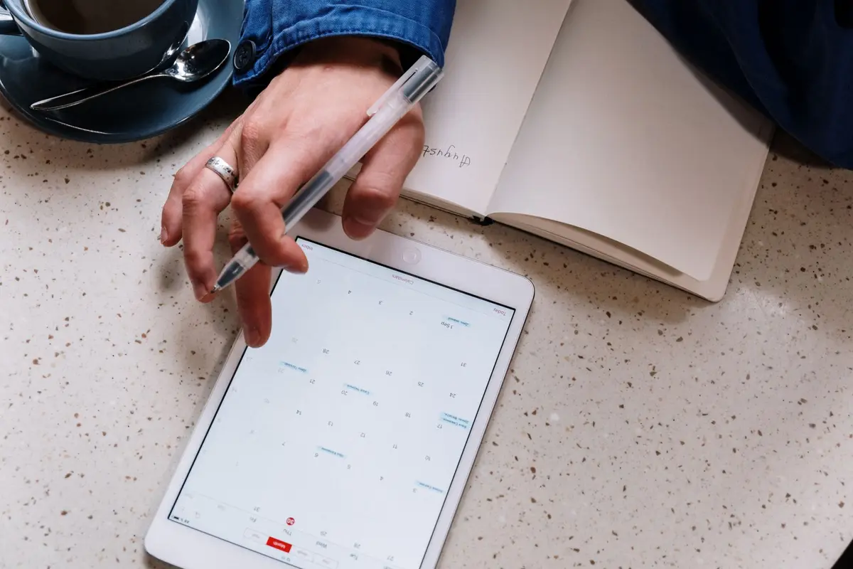 Planning the week on a tablet with a notebook