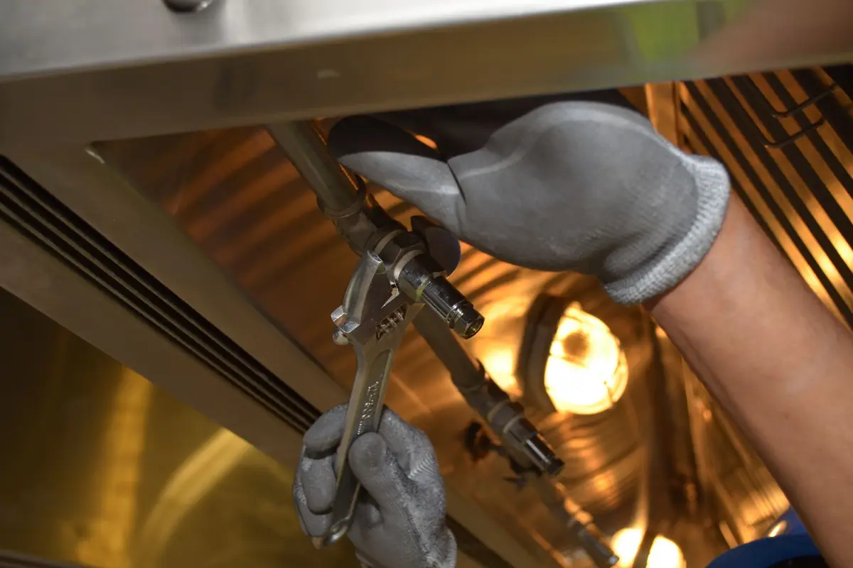 Plumber fixing pipes with a wrench