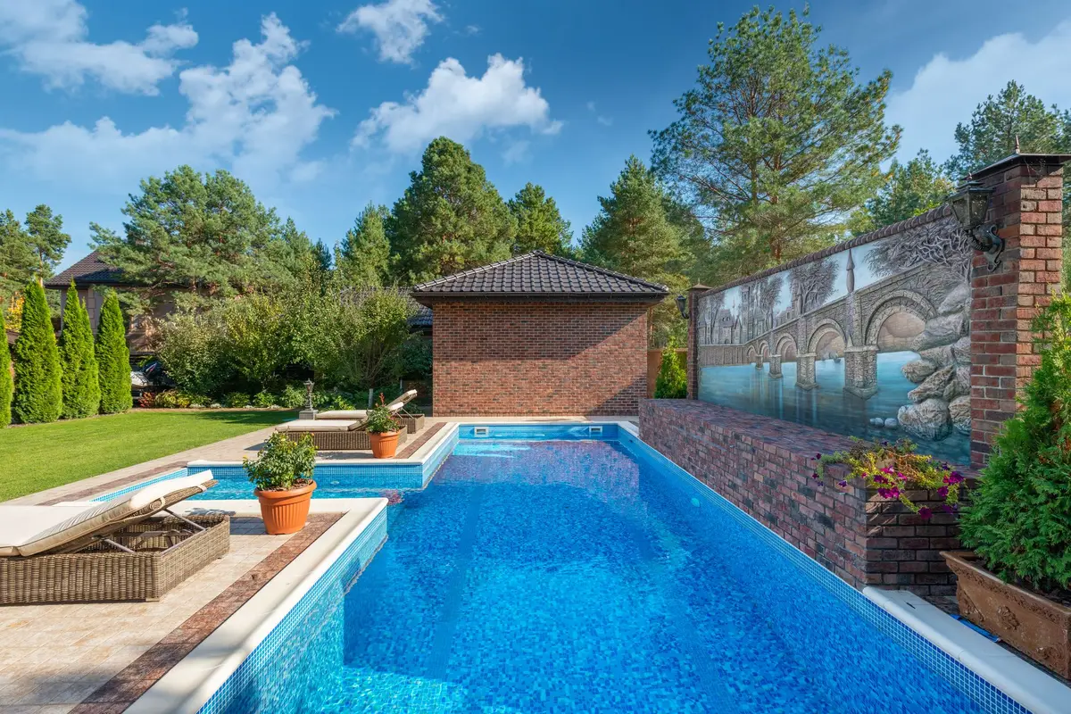 Brick house with a backyard swimming pool
